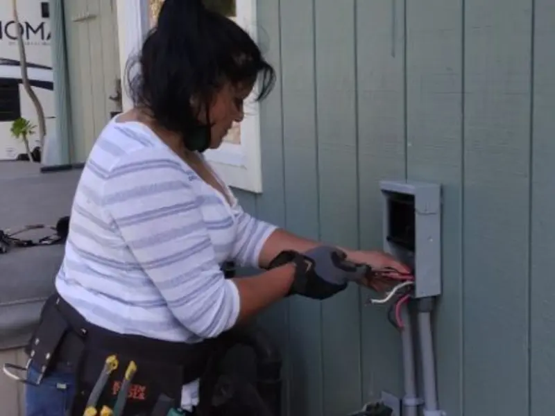 Licensed electrician wiring an exterior subpanel in Teague